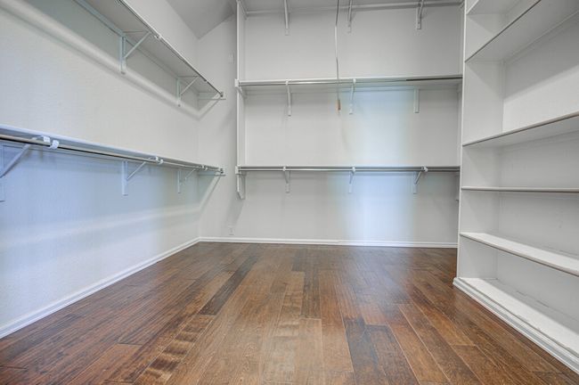 Walk in closet featuring wood-type flooring | Image 23