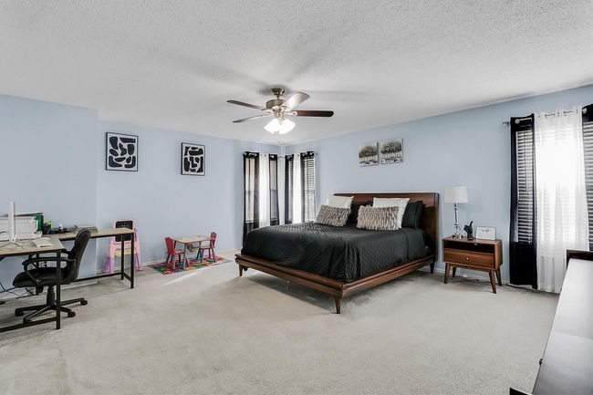 Carpeted bedroom featuring a textured ceiling and ceiling fan | Image 12