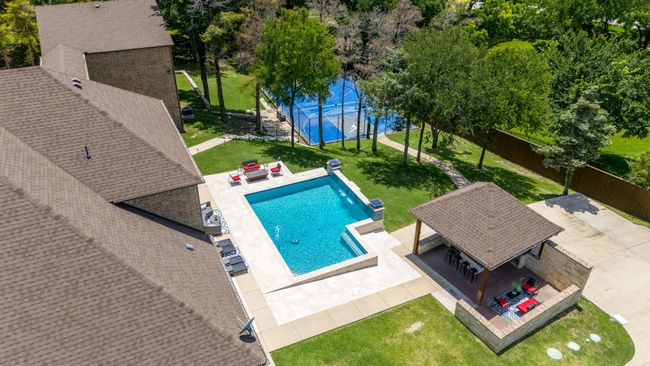 Aerial view of property and surrounding area featuring a pool area | Image 39