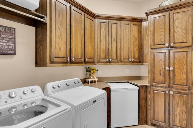 Utility room with cabinet space and ice maker | Image 25