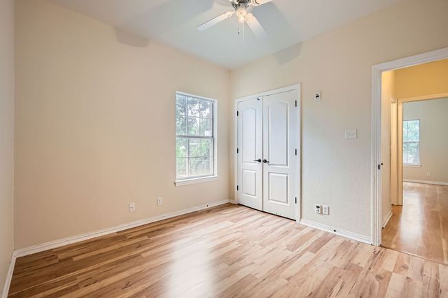 Unfurnished bedroom with light wood-style floors, baseboards, a closet, and a ceiling fan | Image 15