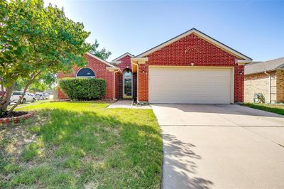 View of front of home with a garage and a front lawn | Image 1