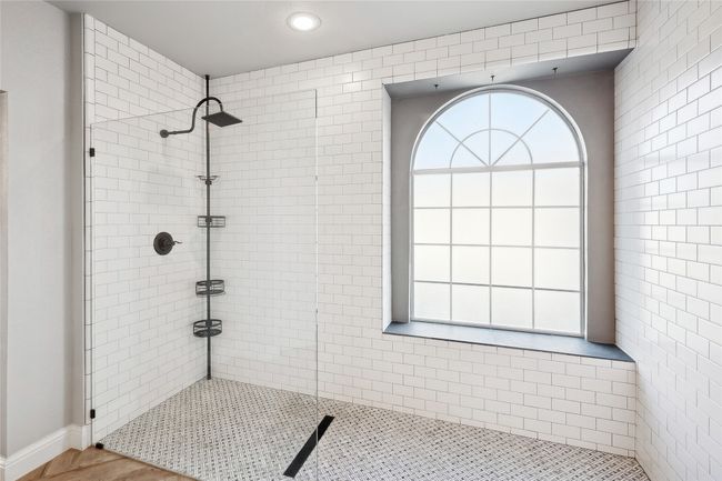 Bathroom featuring tiled shower and hardwood / wood-style floors | Image 19