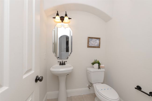 Half bathroom with toilet and tile patterned flooring | Image 22