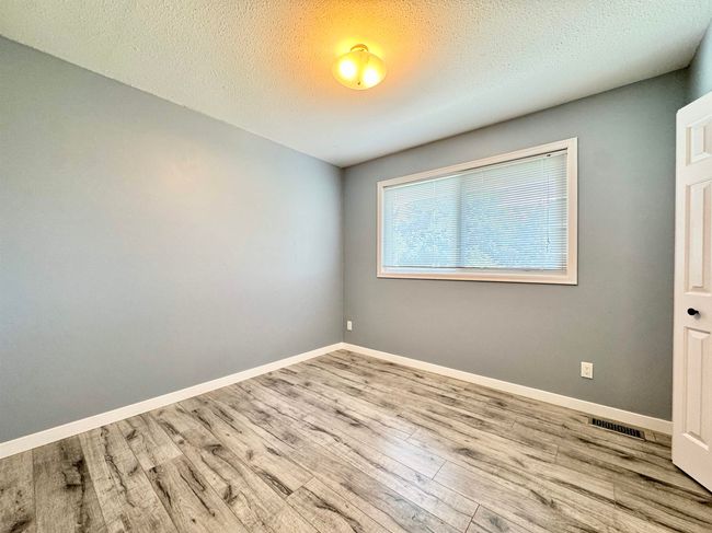Spare room with wood finished floors and a textured ceiling | Image 17