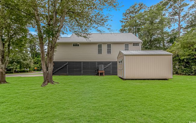 Rear view of property with a lawn and metal roof | Image 32