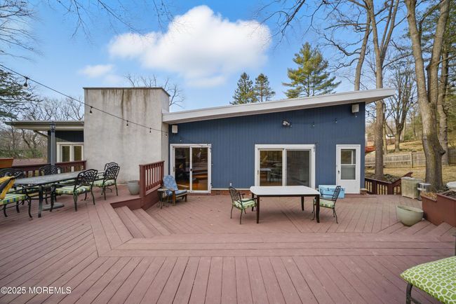 LARGE deck with privacy & nature with sliders to spacious living room & eat in Kitchen with separate Dining, Coffee bar, SS appliances and laundry room! | Image 48