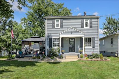 View of front facade featuring a front yard, a patio area, and a gazebo | Image 1