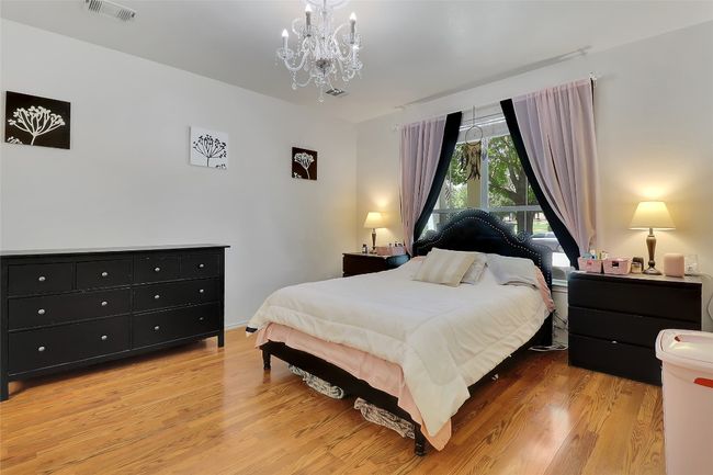 Primary Bedroom with a chandelier and light wood-style flooring | Image 4