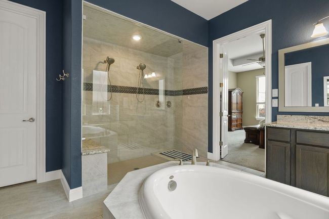 Bathroom featuring extra large shower with dual shower heads and frameless glass | Image 24