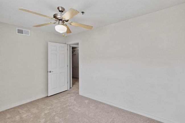 Unfurnished room featuring carpet floors and a ceiling fan | Image 30