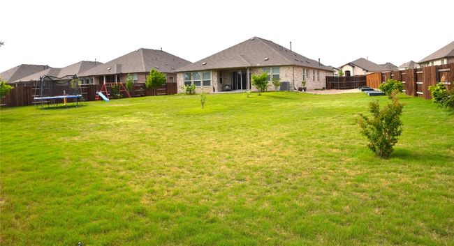 View of yard with a trampoline and central AC unit | Image 31