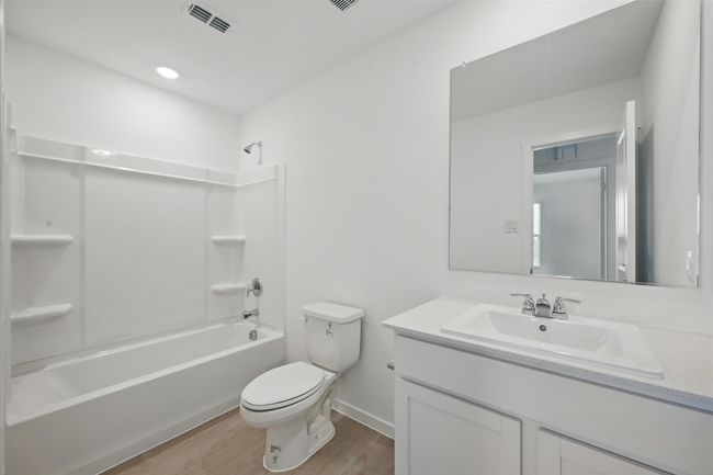 Full bathroom featuring wood finished floors, vanity, and bathtub / shower combination | Image 18