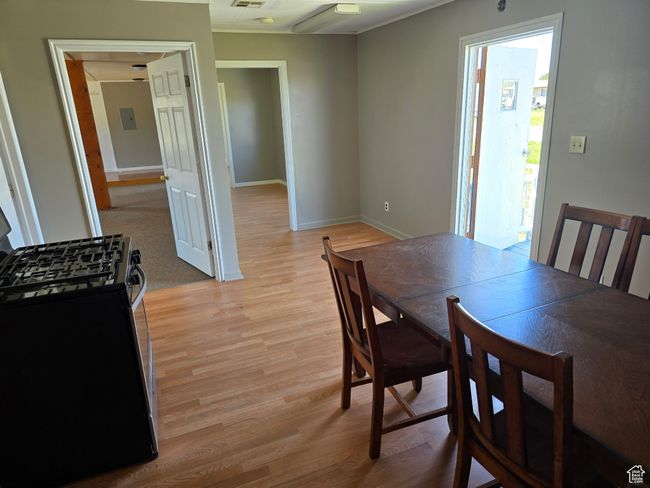 Dining space with baseboards, visible vents, and light wood finished floors | Image 10