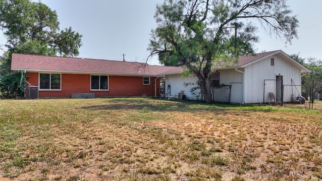 Rear view of house with cooling unit and brick siding | Image 11