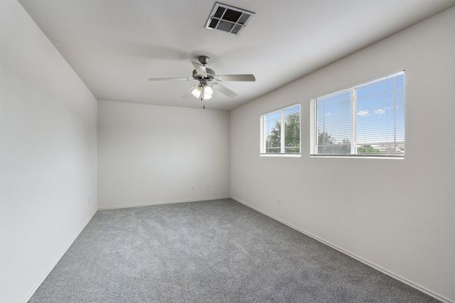 Carpeted empty room with a ceiling fan and baseboards | Image 16