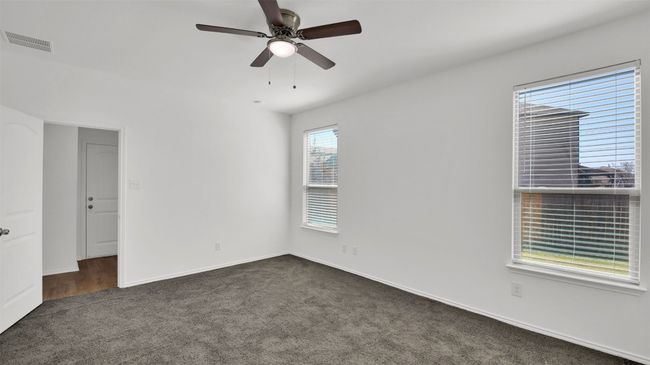 Empty room featuring baseboards, carpet, visible vents, and a ceiling fan | Image 22