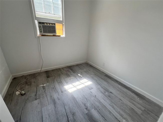 Unfurnished room with cooling unit and hardwood / wood-style flooring | Image 4