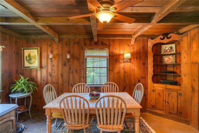Dining room featuring beamed ceiling, coffered ceiling, ceiling fan, and wood ceiling | Image 8