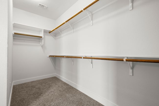 Spacious closet with carpet flooring | Image 14