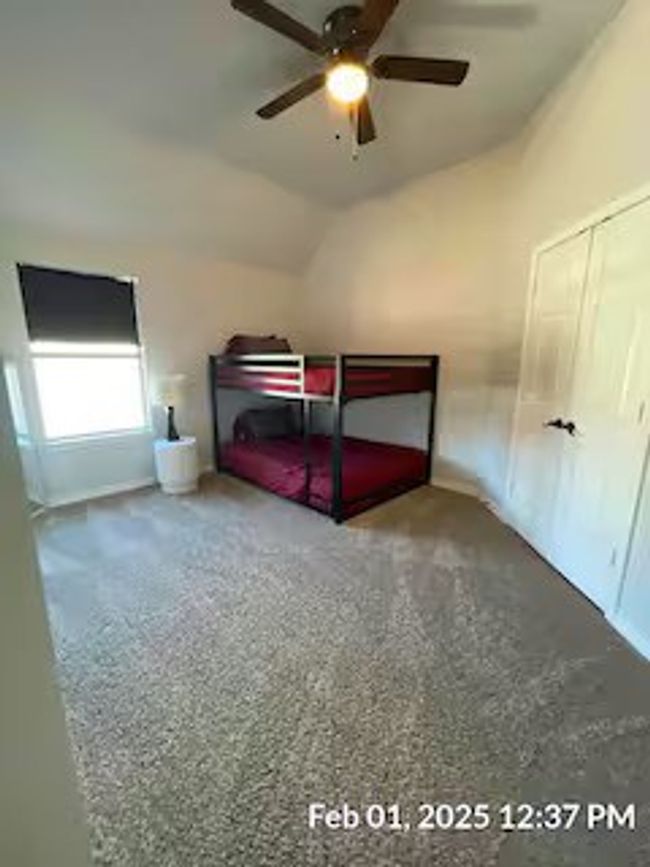 Unfurnished bedroom with lofted ceiling, carpet floors, and ceiling fan | Image 17
