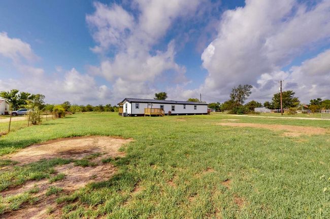 View of green lawn featuring a deck | Image 9