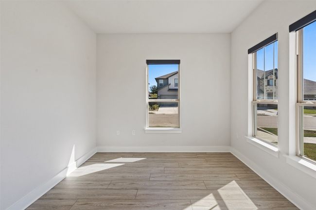 Spare room with healthy amount of natural light and wood finished floors | Image 16