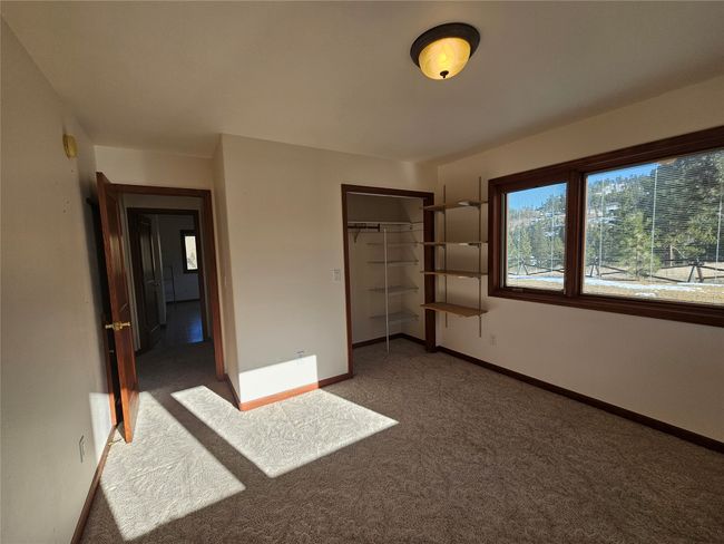 This is one of the two other bedrooms on the main floor. Please note the view from the windows. | Image 19