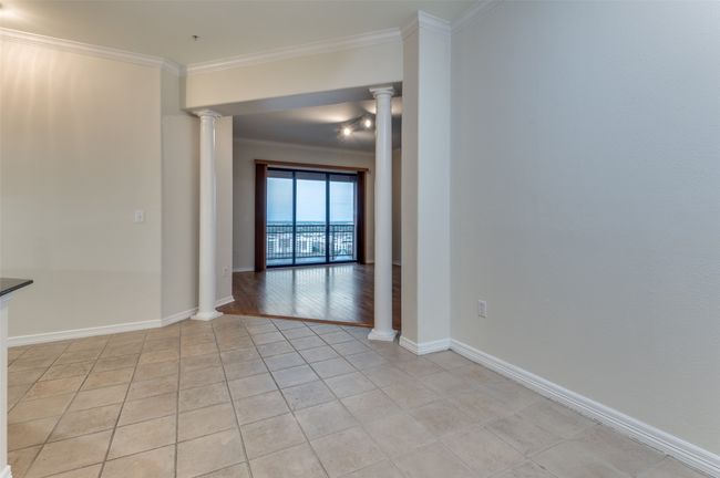 The generously sized dining room offers plenty of space for a table that comfortably seats eight—perfect for hosting dinner parties or family gatherings—and is conveniently positioned right next to the kitchen for effortless serving and connection. | Image 25
