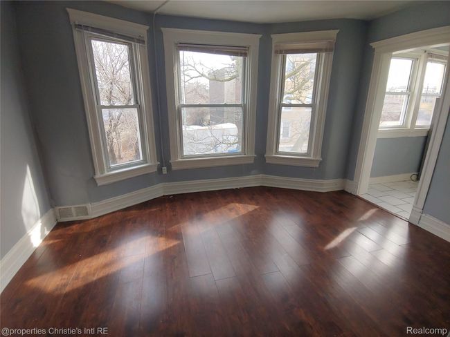 Spare room with baseboards and wood finished floors | Image 10