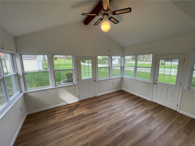 Unfurnished sunroom featuring beamed ceiling and a wealth of natural light | Image 39