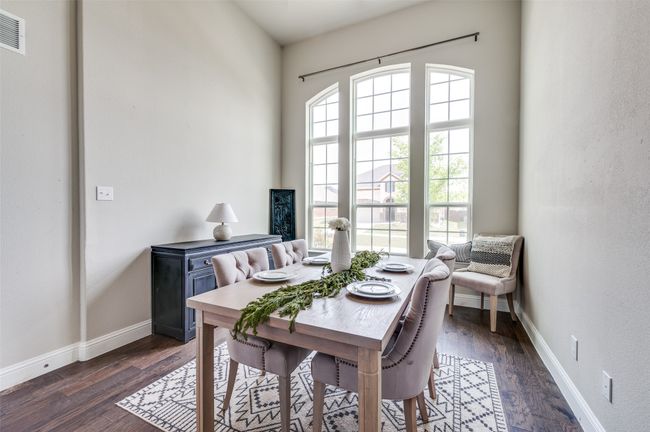 Dining room with dark wood-type flooring, visible vents, and baseboards | Image 14