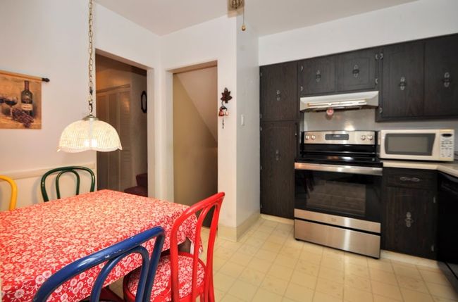 Kitchen has a cute area for quick meals. | Image 16