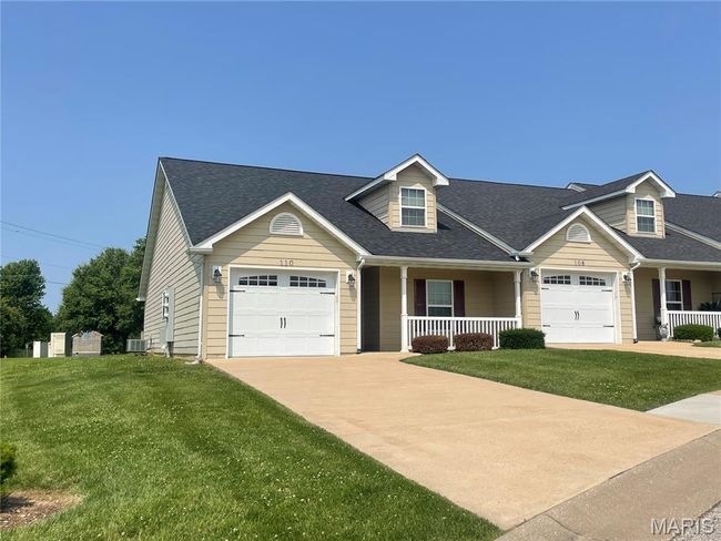 View of front of property featuring covered porch, concrete driveway, an attached garage, a front yard, and roof with shingles | Image 4