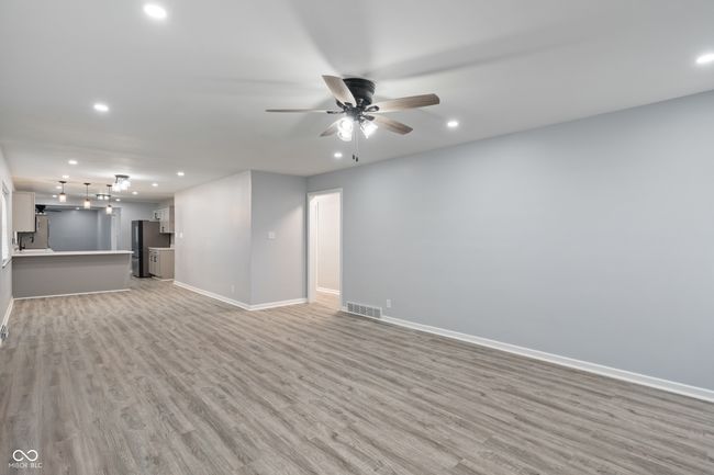 unfurnished living room featuring baseboards, light wood finished floors, recessed lighting, and ceiling fan | Image 7