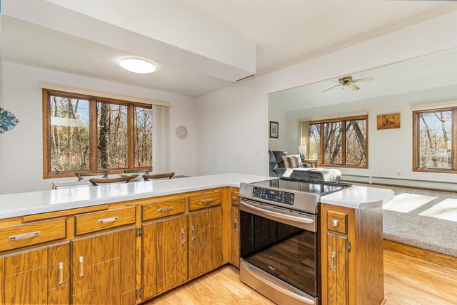If you love to entertain, this space is perfect. The kitchen is open to the dining and living areas. The lengthy counter makes for a great buffet space. Cook your favorite recipes on the induction flat top stove with an air fryer built-in. | Image 16