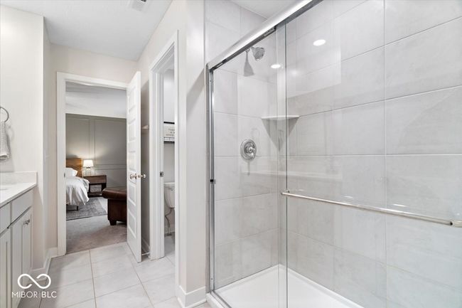 full bath with ensuite bath, a stall shower, vanity, and tile patterned floors | Image 25