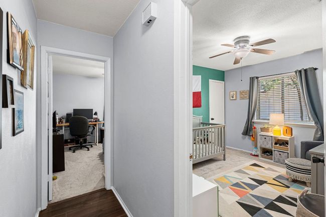 Corridor with an office area, baseboards, wood finished floors, and a textured ceiling | Image 20