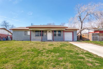 Single story home with a garage and a front yard | Image 1