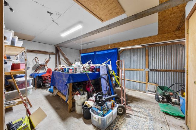 This is a 2 car garage without shelving. With the built-in shelving it would work as a storage room. | Image 16