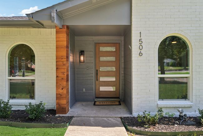 Entrance to property with brick siding and a porch | Image 6