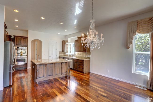 Kitchen with stainless steel appliances, recessed lighting, arched walkways, and a sink | Image 18