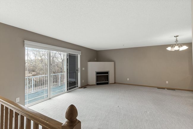 Bright living room with large slider with pond views. | Image 4