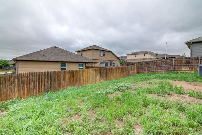 View of yard with central AC unit and a fenced backyard | Image 29