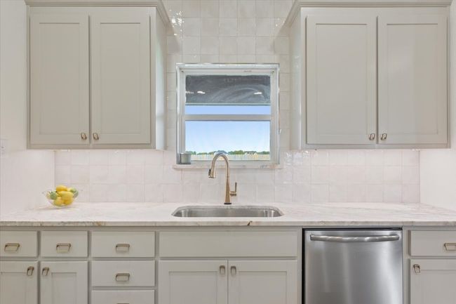 Kitchen with dishwasher, tasteful backsplash, light stone counters, and white​​‌​​​​‌​​‌‌​‌‌​​​‌‌​​‌‌​‌​​​​​‌ cabinets | Image 13
