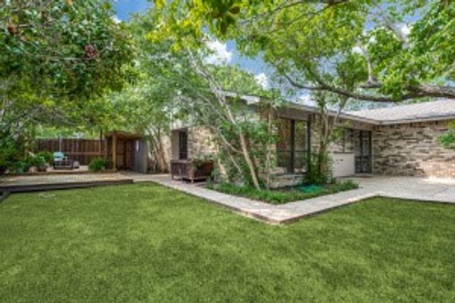 Rear view of house with a yard and fence | Image 23