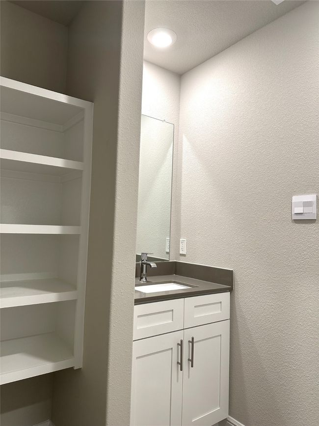 Bathroom featuring vanity and a textured wall | Image 16