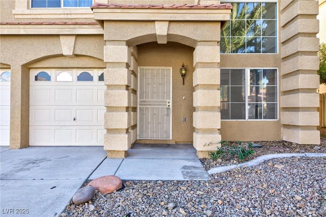 Entrance to property featuring stucco siding and concrete driveway | Image 43