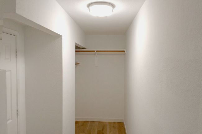 Walk in closet featuring light wood finished floors | Image 29