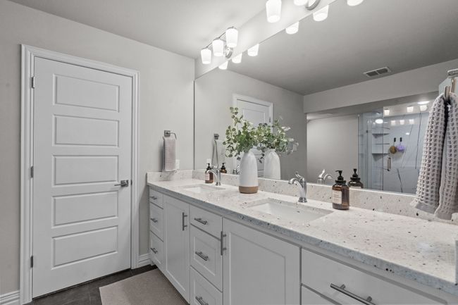 Bathroom featuring double vanity, a stall shower, and tile patterned floors | Image 20